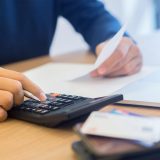 man_taxes_calcluator_laptop